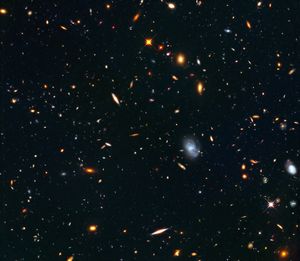 Small, distant galaxies of myriad shapes--spirals, ellipticals and irregular shapes--against the black background of space.